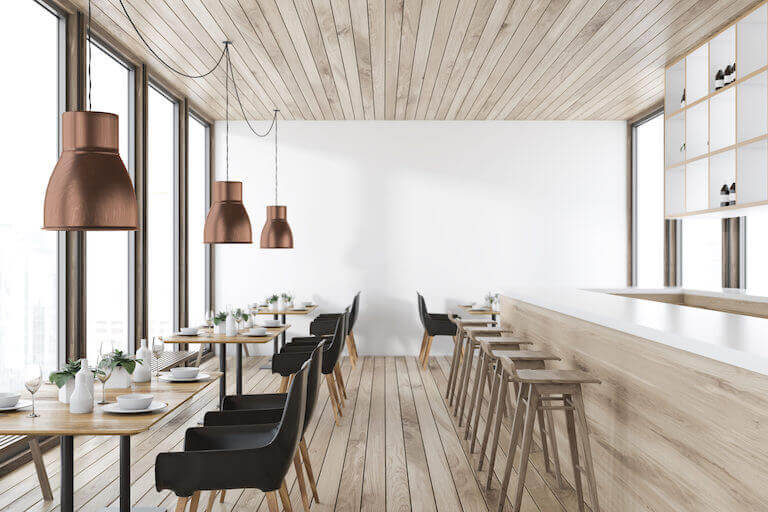 restaurant interior with black chairs and wooden ceiling