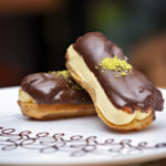 Chocolate pastry eclair dessert on white plate