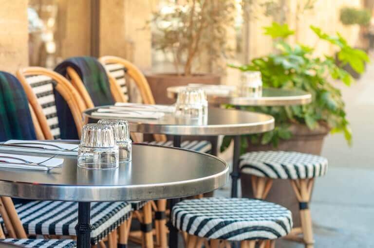 Outdoor patio of a restaurant with black and white chairs