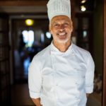 Portrait of chef standing with hands behind back