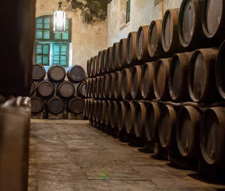 Rows of dark oak wine barrels