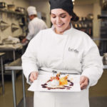 Smiling woman holding white plate with sorbet dessert