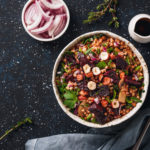 Healthy salad with nuts, craisins, and bowl of onions