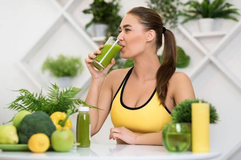 Woman drinking a green smoothie