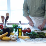 chef chopping asparagus and other vegetables with knife
