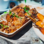 plant based dish with rolls in a tray covered with sauce