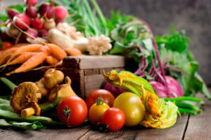 Fresh vegetables displayed on a wooden table