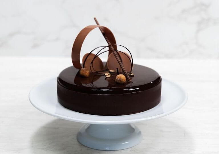 Chocolate Entremet Cake on a white cake stand