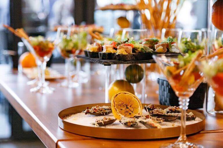 appetizers carefully displayed on a wooden table at an event 