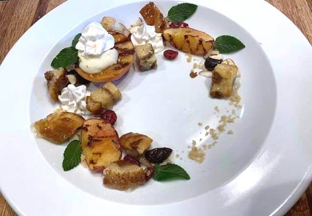 Grilled peaches with glazed cinnamon coffee cake croutons, banana pudding, frozen chantilly cream, dried berries and sliced almonds