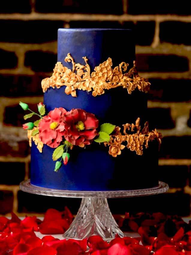 jewel toned purple wedding cake with flowers