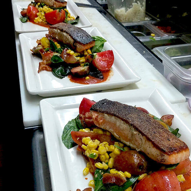 Pan Seared Faroe Island Salmon with local heirloom tomatoes, fresh basil, grilled corn and roasted tomato vinaigrette