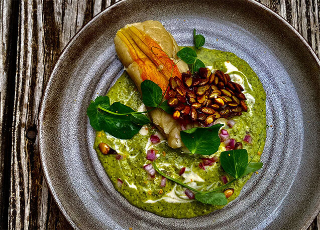 Squash Blossom Tamale with Mole Verde, Cashew Crema, and Pumpkin Seed Brittle