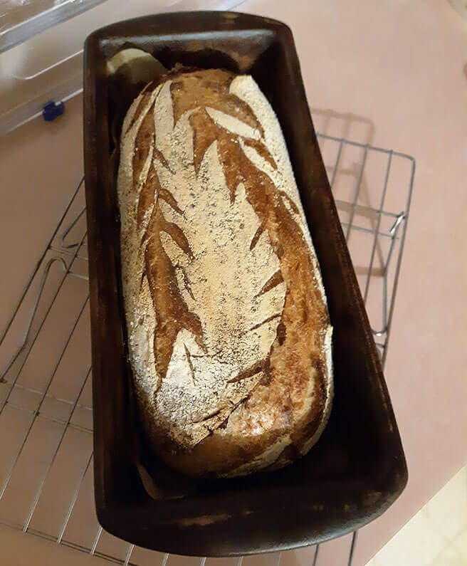 rustic sourdough bread in a rectangular bread pan