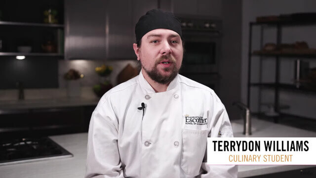 Culinary student Terrydon Williams in uniform in a kitchen