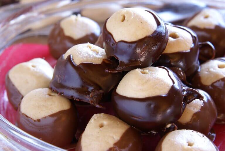 Close up image of buckeye candies in a clear glass bowl