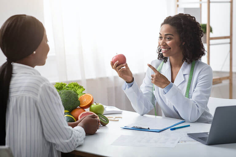 Nutritionist consulting with client at their desk