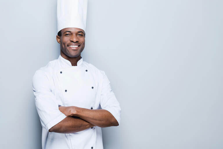 https://www.escoffier.edu/wp-content/uploads/2022/03/Smiling-male-chef-with-white-coat-and-hat-768.jpg