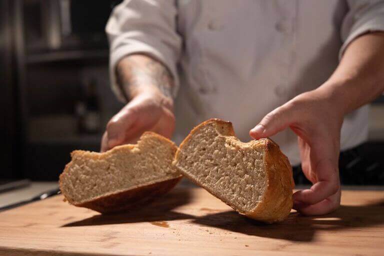  Chef holding a sweet oat loaf cut in half