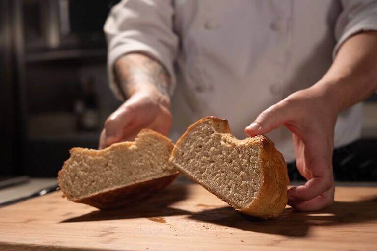 Chef holding a sweet oat loaf cut in half