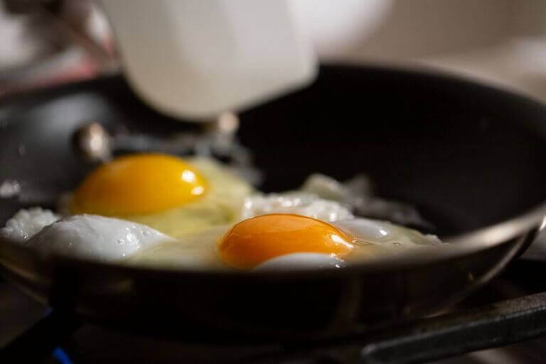 Close up of an egg cooking in a pan