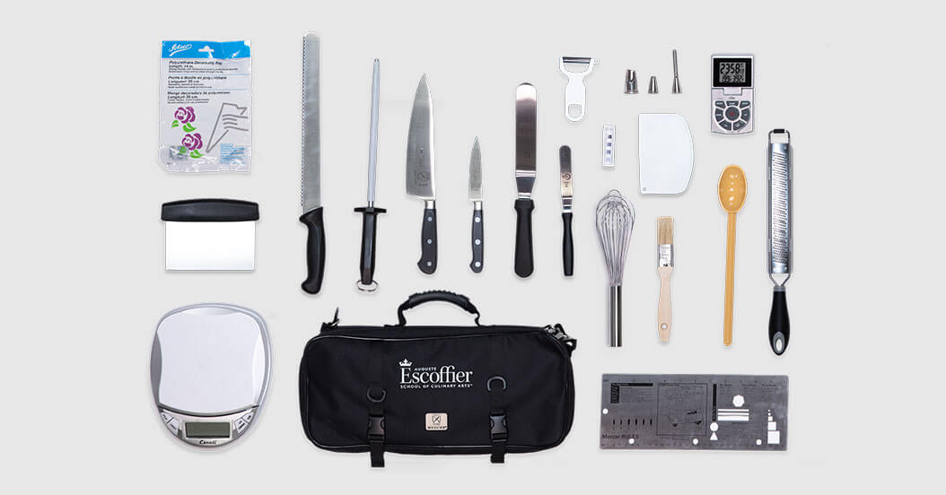 Kitchen toolkit laid out on a white table
