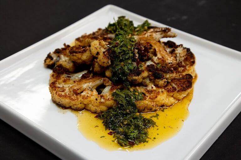 Cauliflower Steak on a white plate