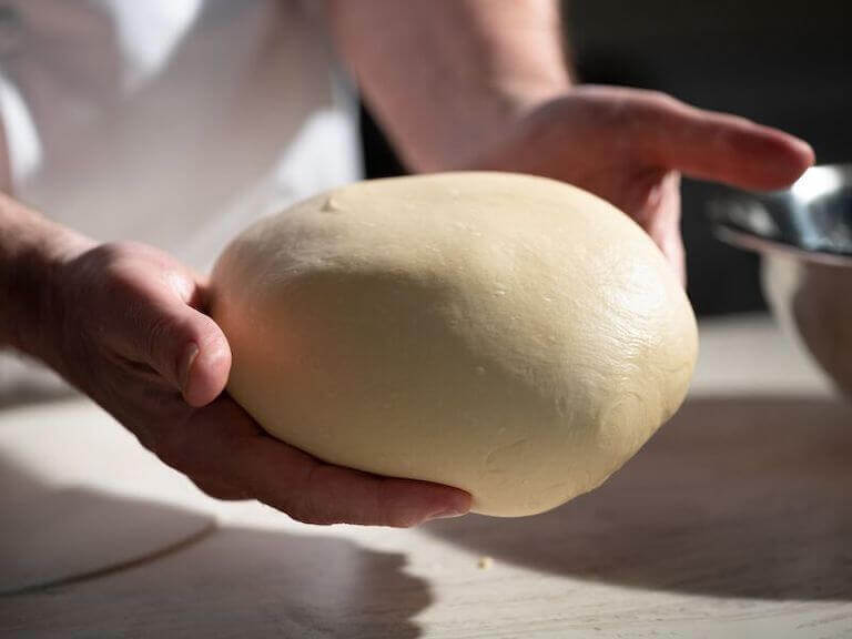 Chef holding ciabatta bread dough