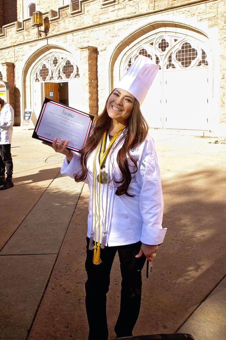 Escoffier graduate posing with diploma 