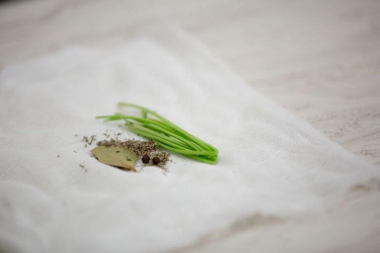 Herbs sitting on an open white sachet