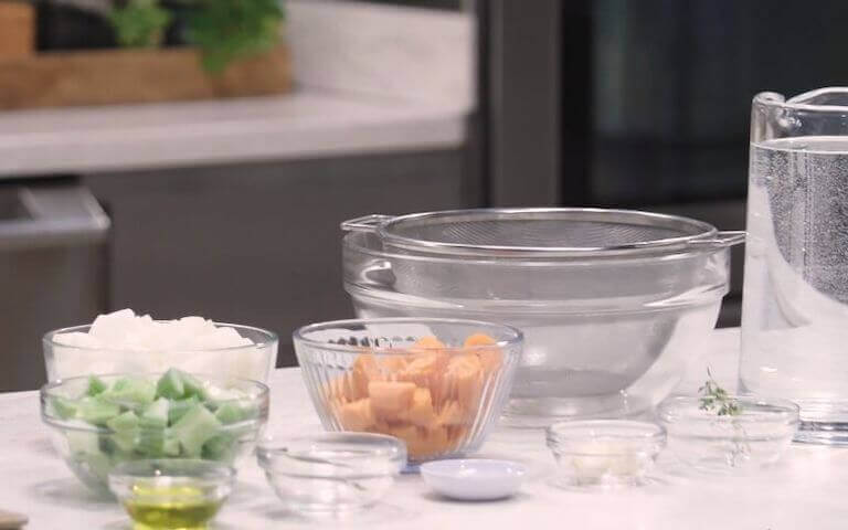 Ingredients for a mirepoix separated into glass bowls