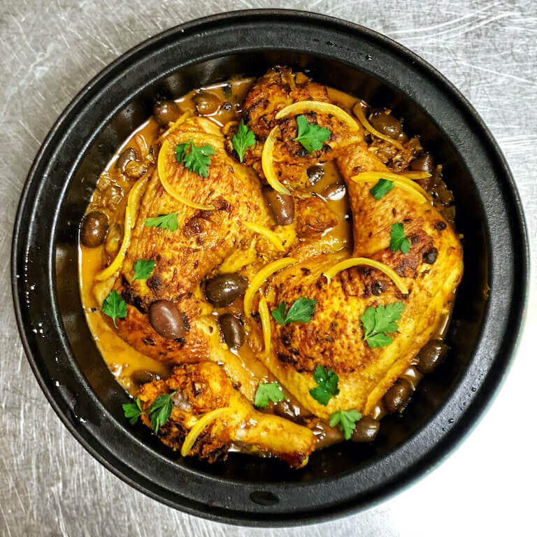 Chicken Tagine with Preserved Lemons in a black bowl 
