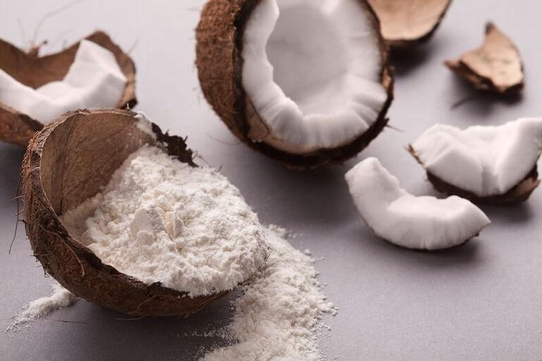 Coconut flour in an empty coconut on a table