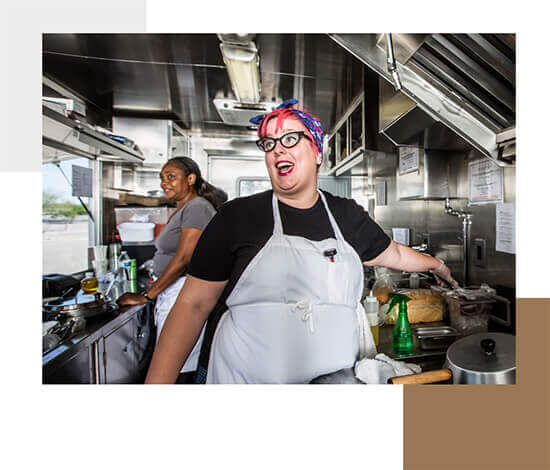 Food truck owner talking inside of her food truck, demonstrating entrepreneurship