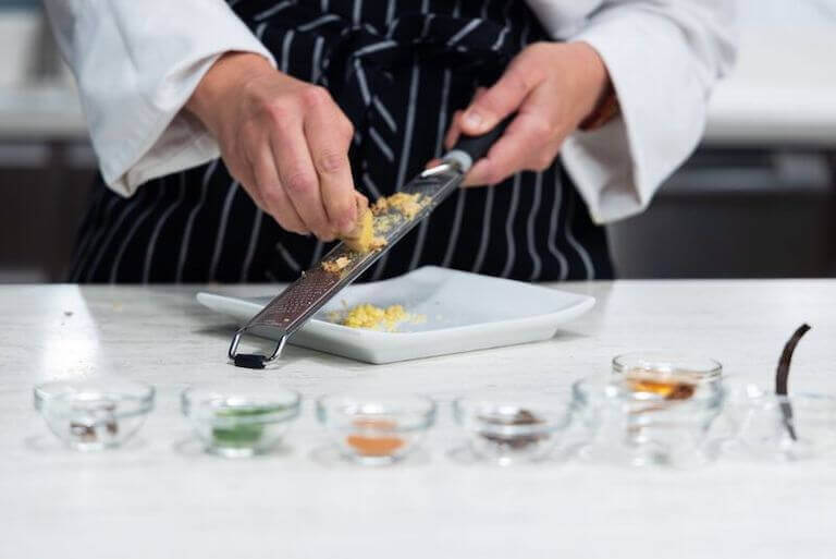 Chef grating ginger for a ginger tea