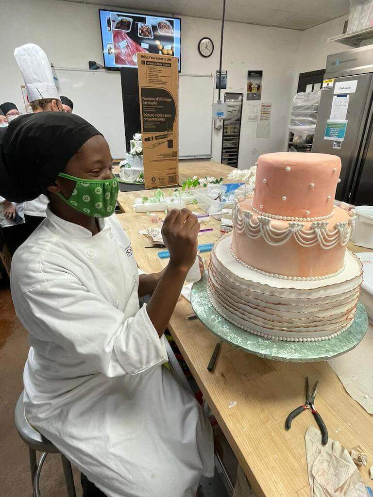 Practicing cake decorating skills at Escoffier.