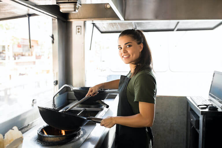 Chef cooking with a wok in a food truck