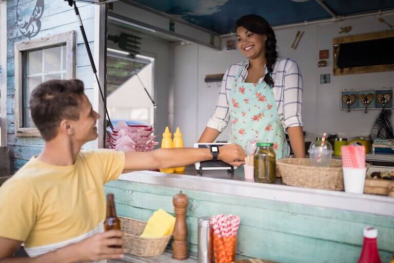 Customer paying at food truck with smart watch