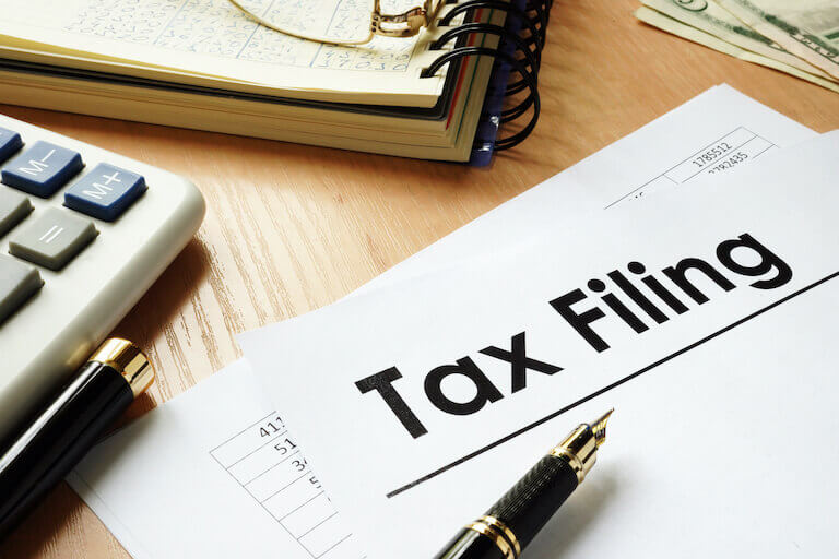 Papers on a desk with the words tax filing at the top