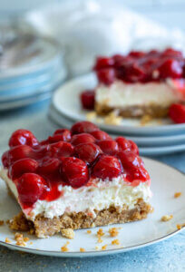 Cherry Yum Yum Pie on white plate with light blue background