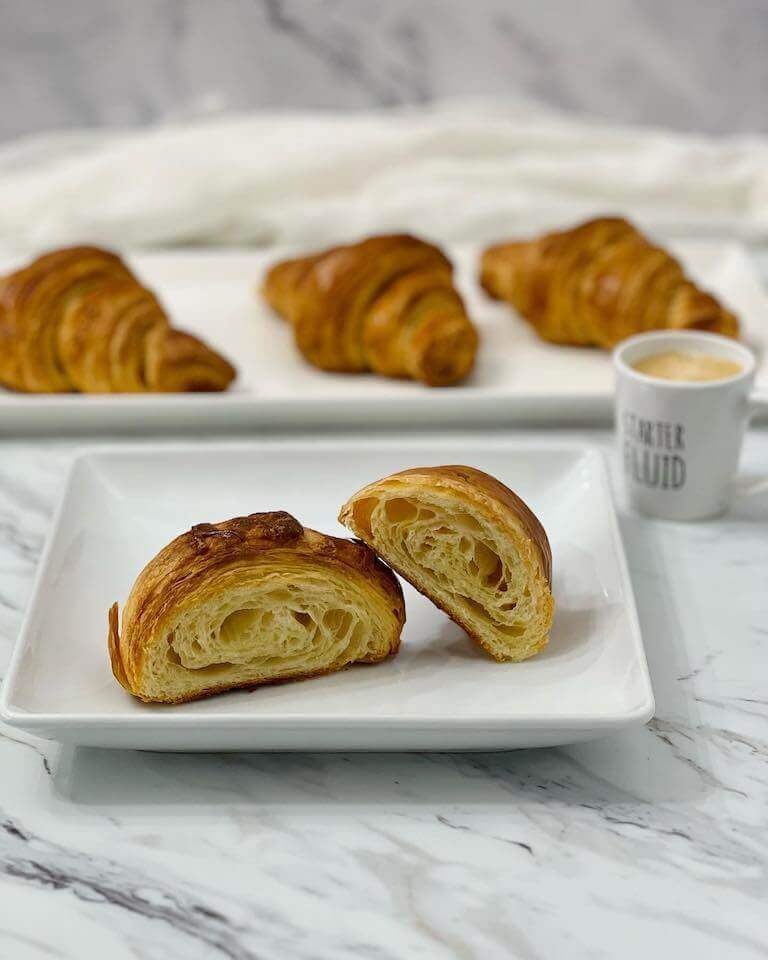 croissants cut in half on a white plate