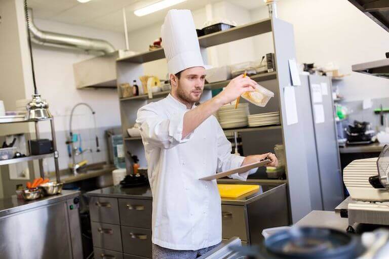 Chef checking date on a food container