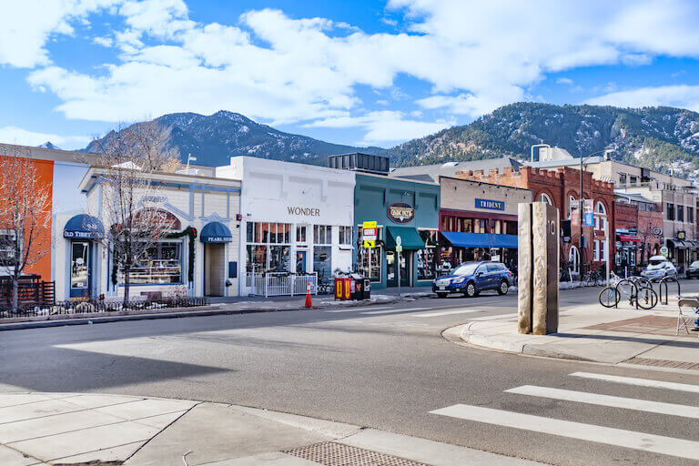 View of shops with mountains in the background in downtown boulder colorado