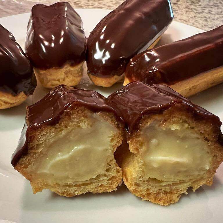 An eclair cut in half to display its filling