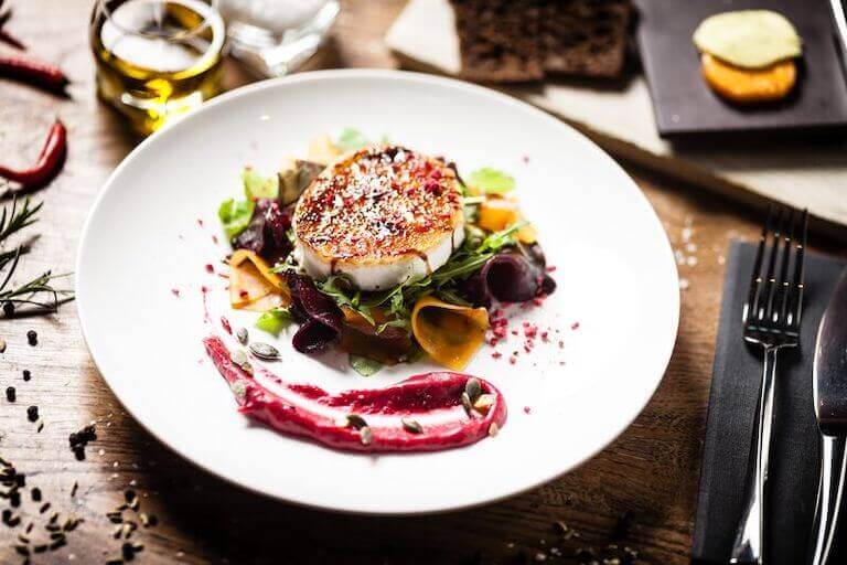 Grilled goat cheese salad with beetroot, cranberry jam, and pumpkin seeds