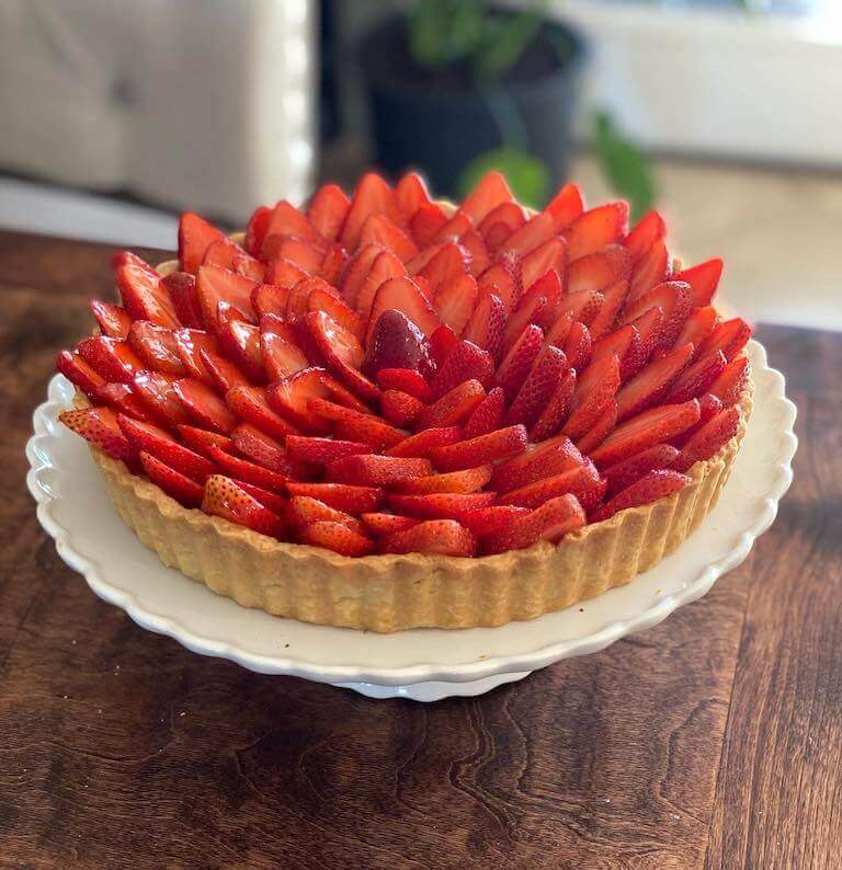 Strawberry tart on a white cake stand