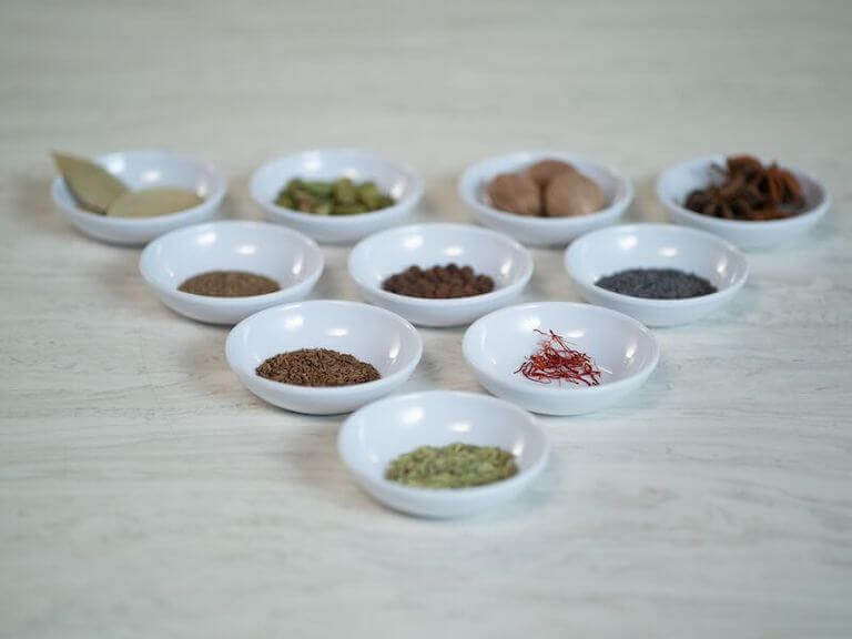 Spices separated and organized in small white dishes