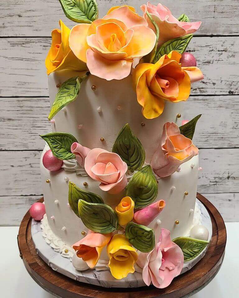 Two tier cake with pink and orange flowers