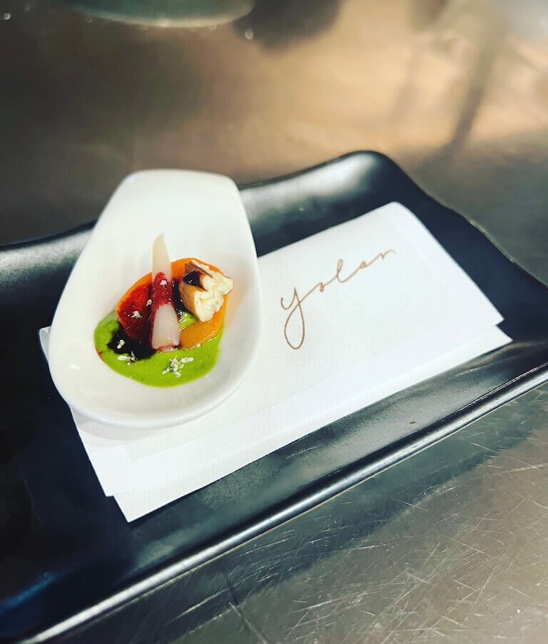 Amuse bouches with Vichy-style glazed carrot with beet molasses, chive aioli, pickled ramp, and toasted pecan