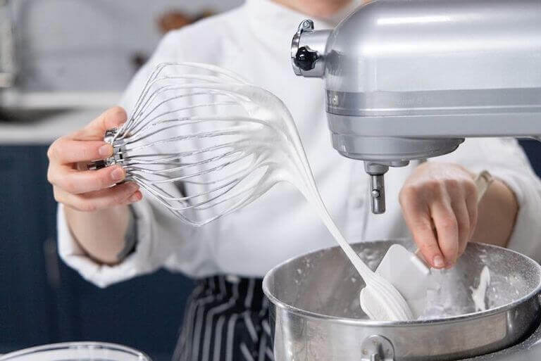 Chef taking fresh meringue out of the mixer